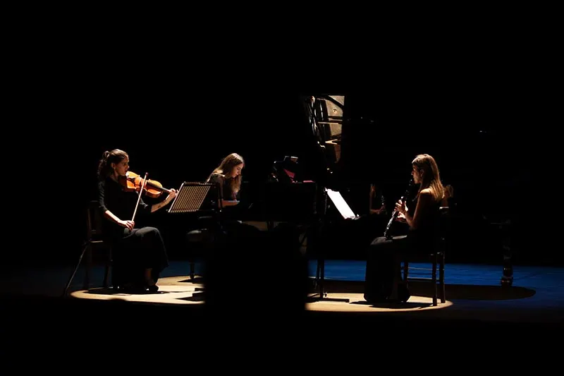 Re:Flexus Trio on stage during a low-lit concert